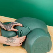 A waxer's hands inserting a brazilian wax key into Sayge's keyhole