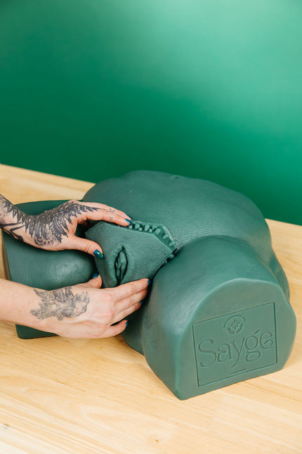 A waxer's hands inserting a brazilian wax key into Sayge's keyhole