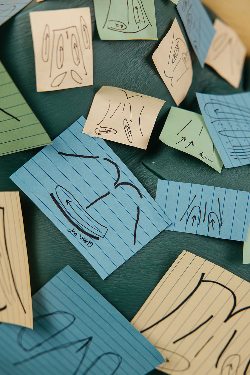 Close up of multiple wax pattern sticky note directions stuck to Sayge the wax training model