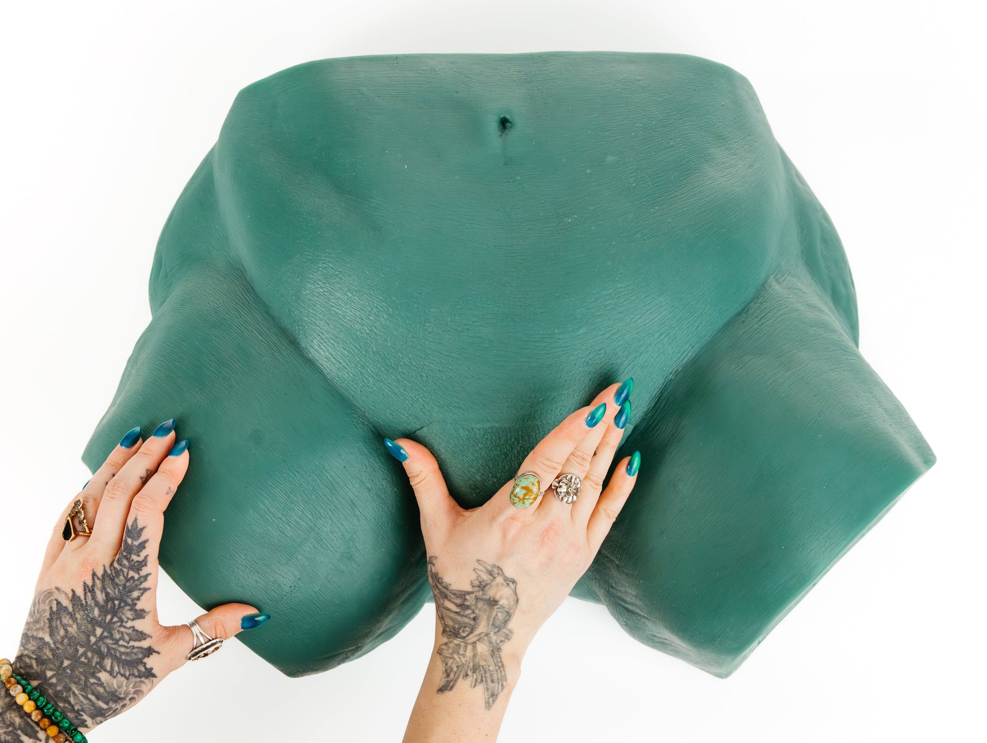 One of Sayge's anatomy keys being inserted into the key slot by tattooed arms