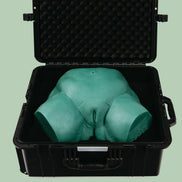 Open protective Travel Case with Sayge the wax training model inside