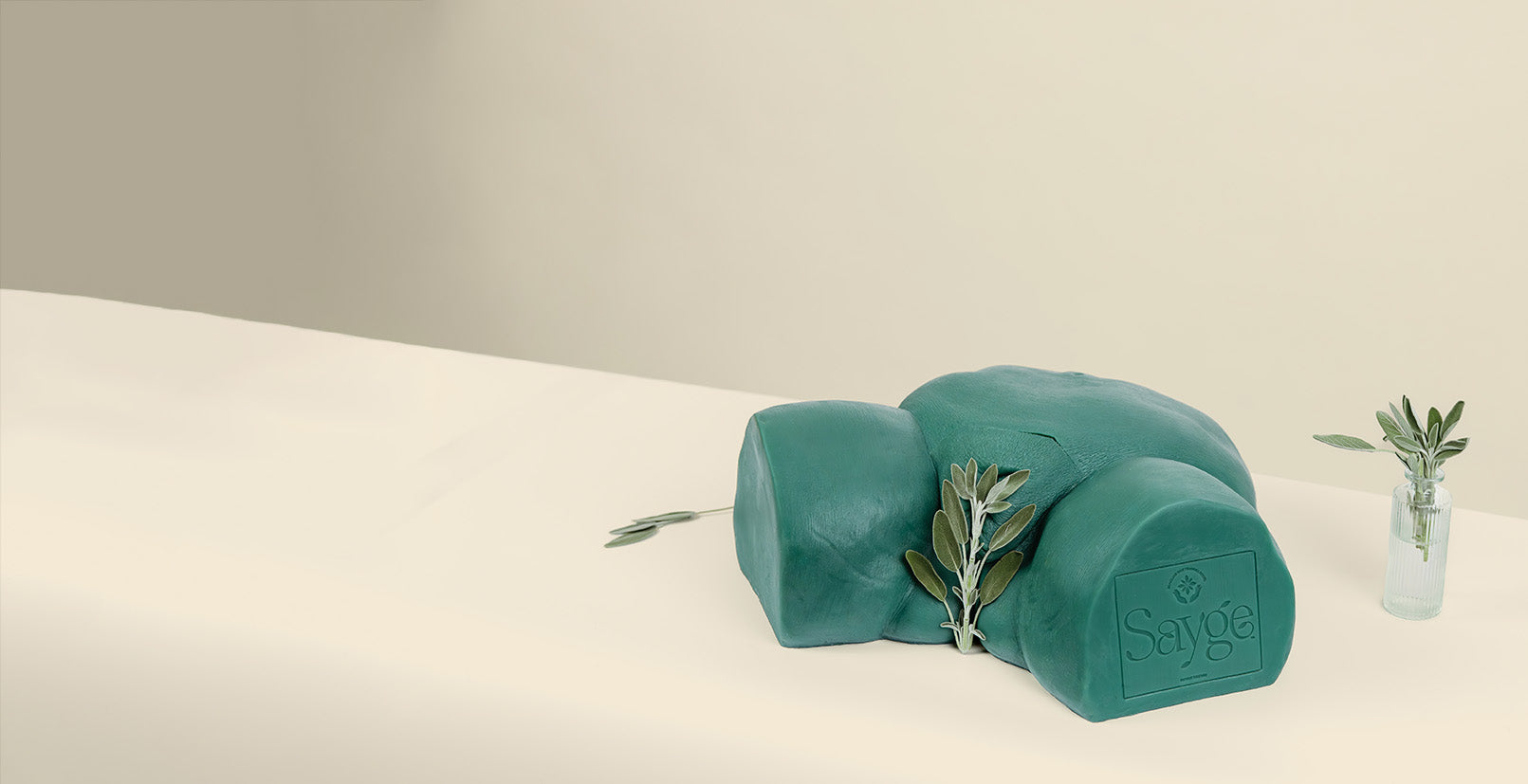 Sayge wax training model with a sage leaf protecting their modesty on a beige background